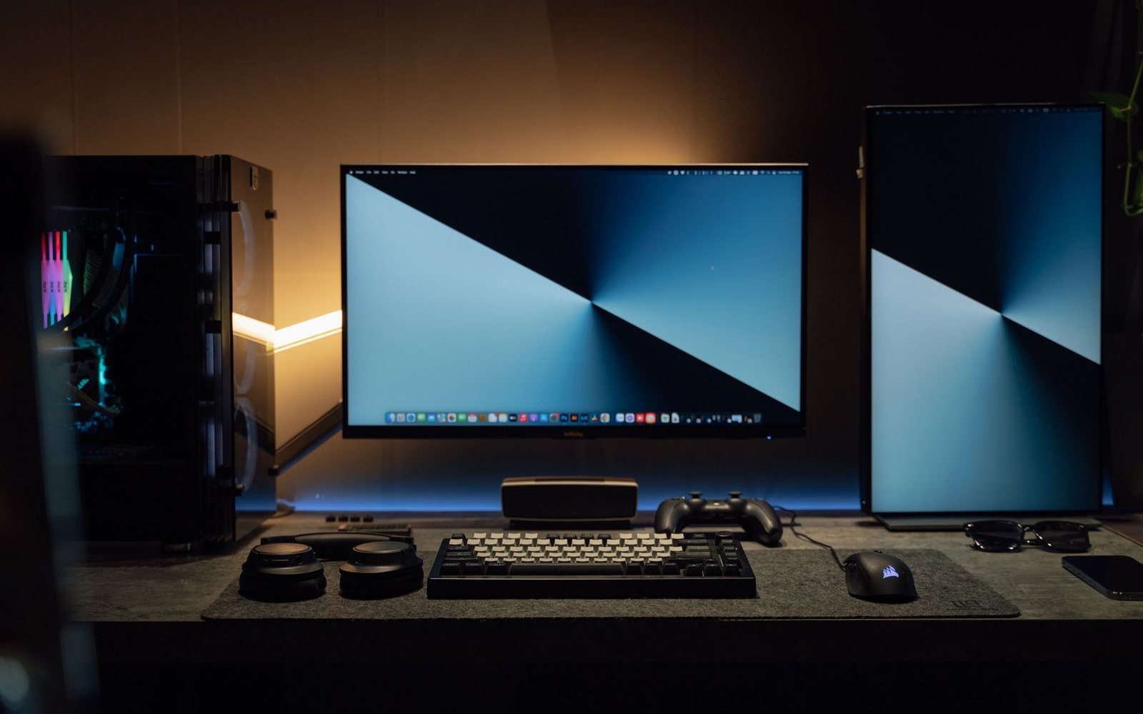 Gaming desk with mechanical keyboard, controller and headphones in warm light