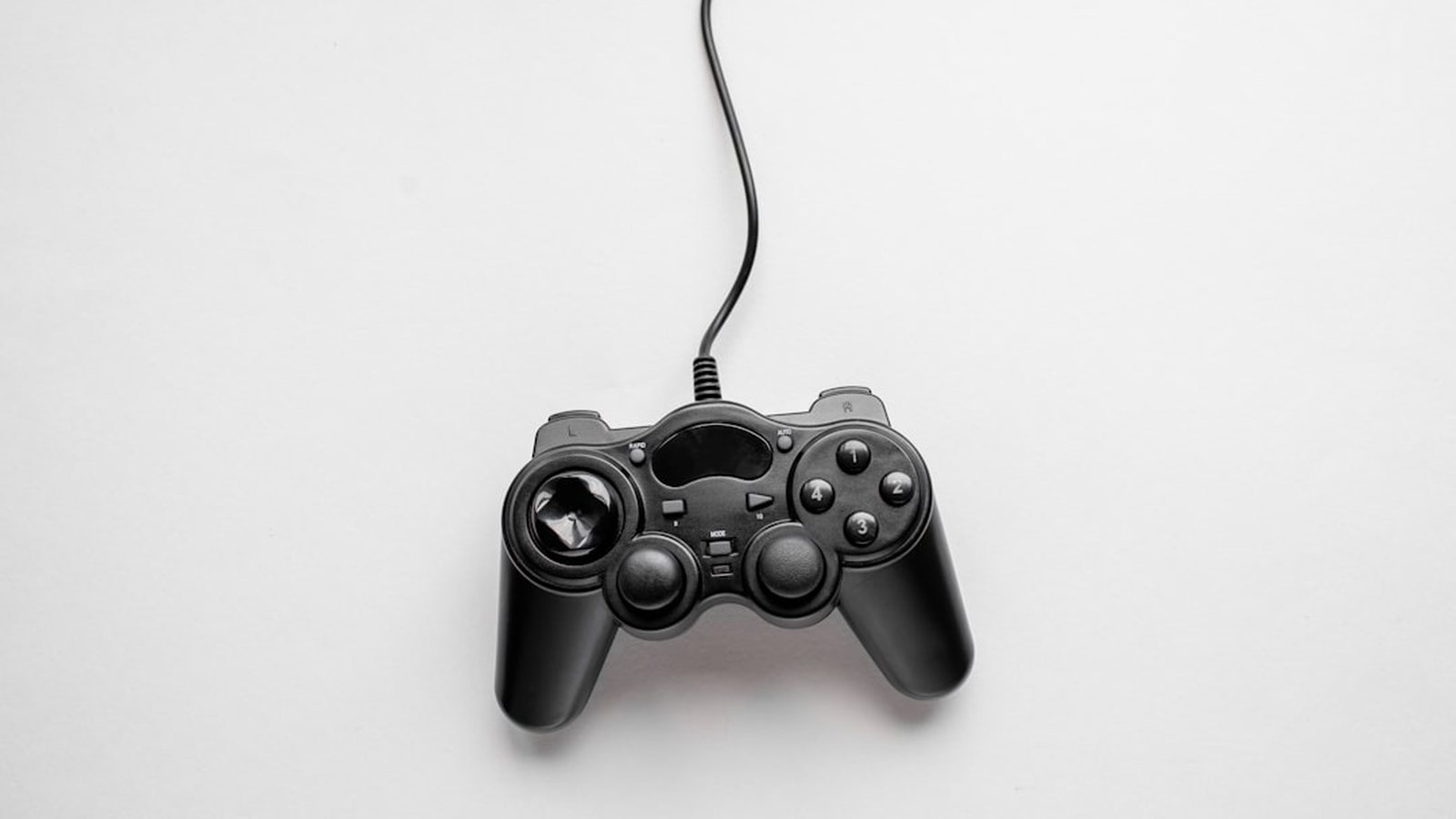 Unbranded game controller on a plain studio background